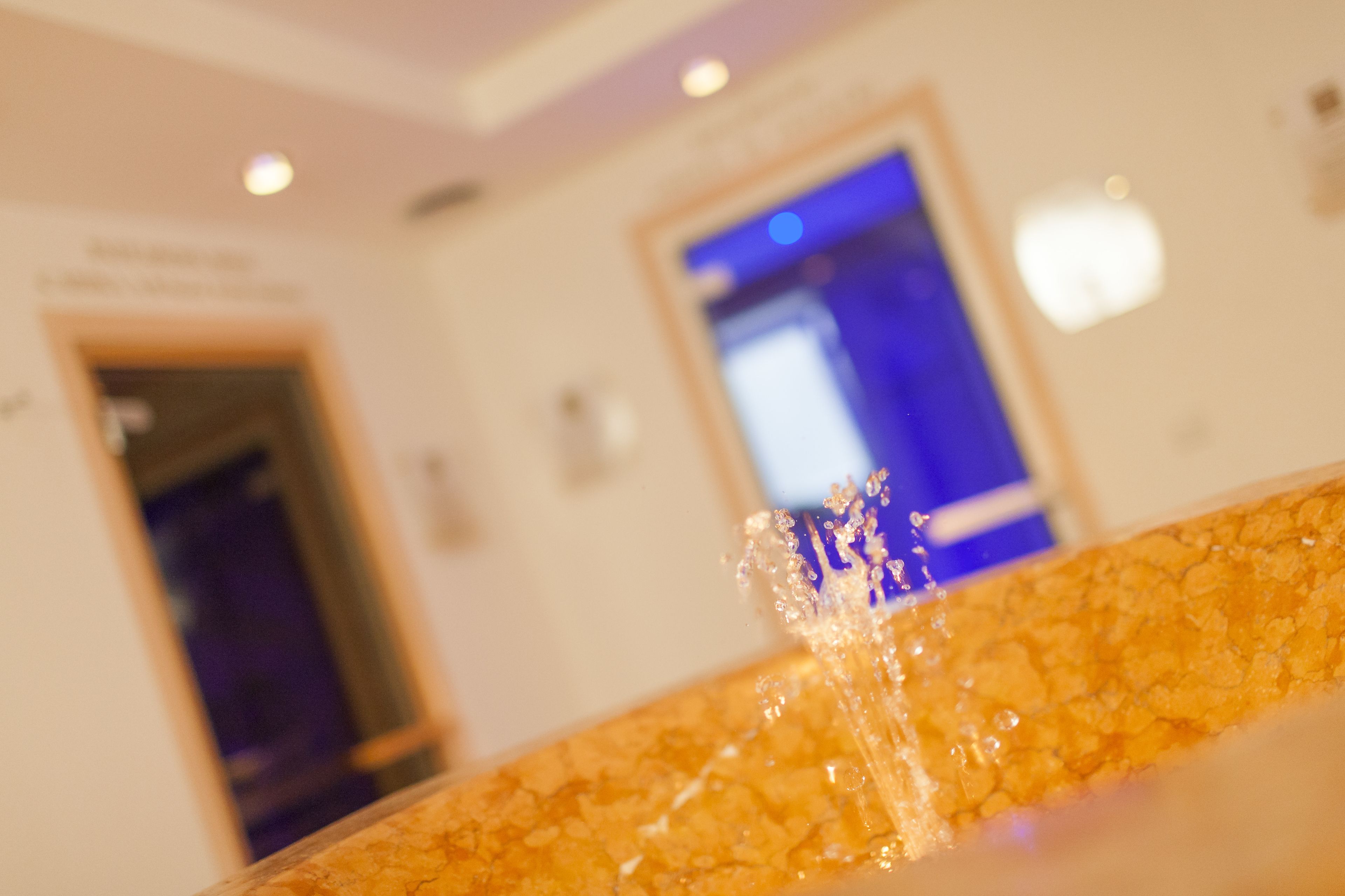 A close-up of a marble countertop with a water feature.