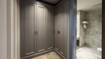 A bathroom with a walk-in shower, a toilet, and a sink.