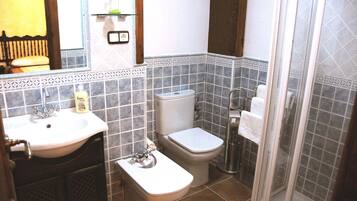 A bathroom with a sink, toilet, and shower.