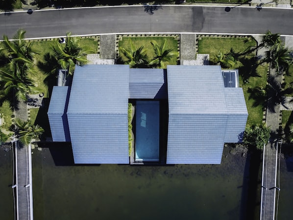 An aerial view of a building with a rectangular layout, a central entrance, and surrounding palm trees. - Vedana Lagoon Resort and Spa (Hue)