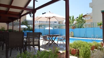 Seasonal outdoor pool, open 9:30 AM to 9:30 PM, pool umbrellas