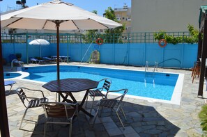Seasonal outdoor pool, open 9:30 AM to 9:30 PM, pool umbrellas