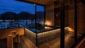 A modern interior with a large window, wooden flooring, and a bar area. - Tendo Onsen TAKINOYU (Tendo)