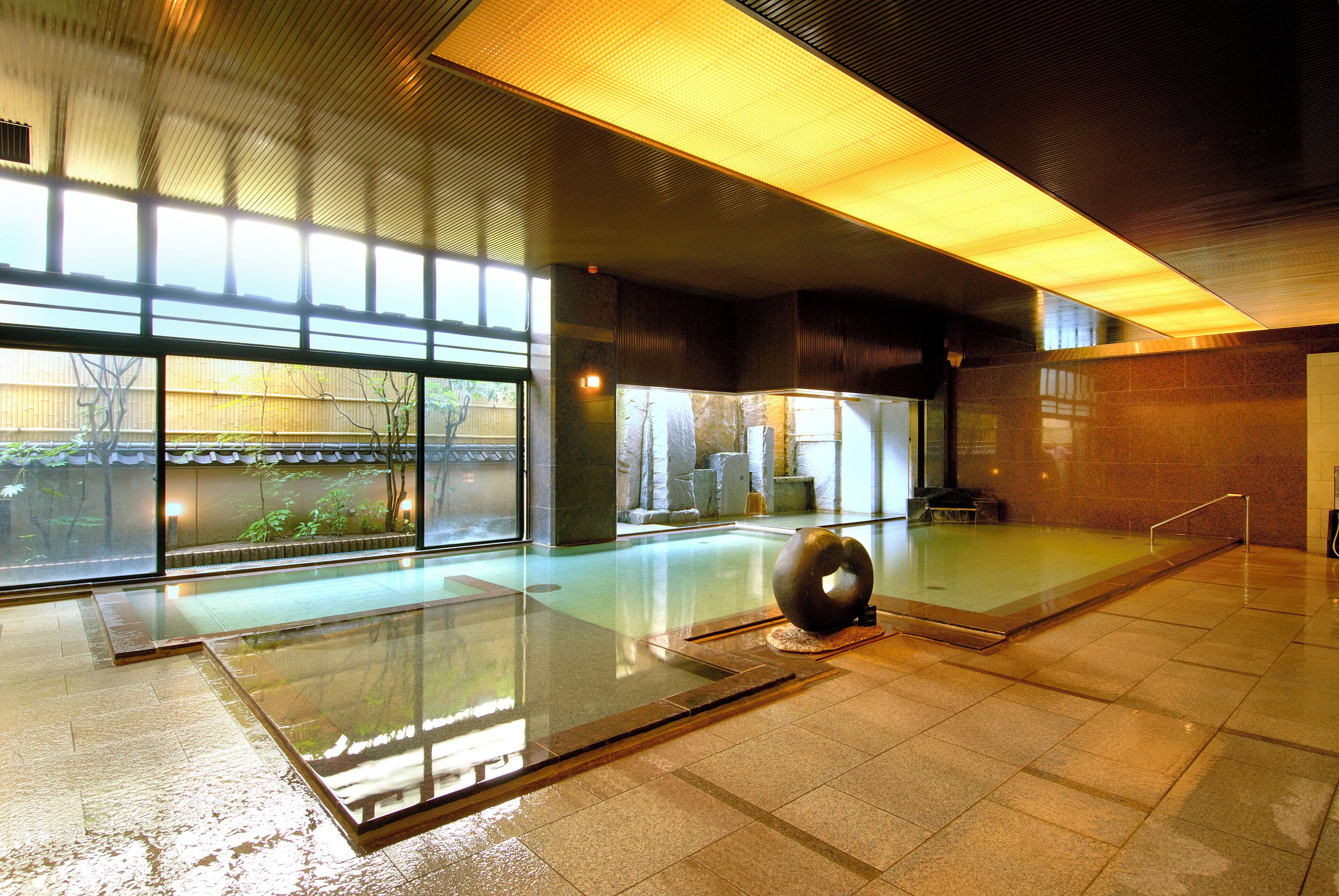 A spacious indoor area with a glass floor, large windows, and a modern design.