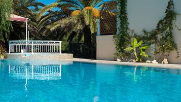 Seasonal outdoor pool, open 10:30 AM to 6:30 PM, pool umbrellas