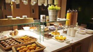 A buffet with various food items and a coffee station. - DoubleTree by Hilton Hotel Girona (Girona)