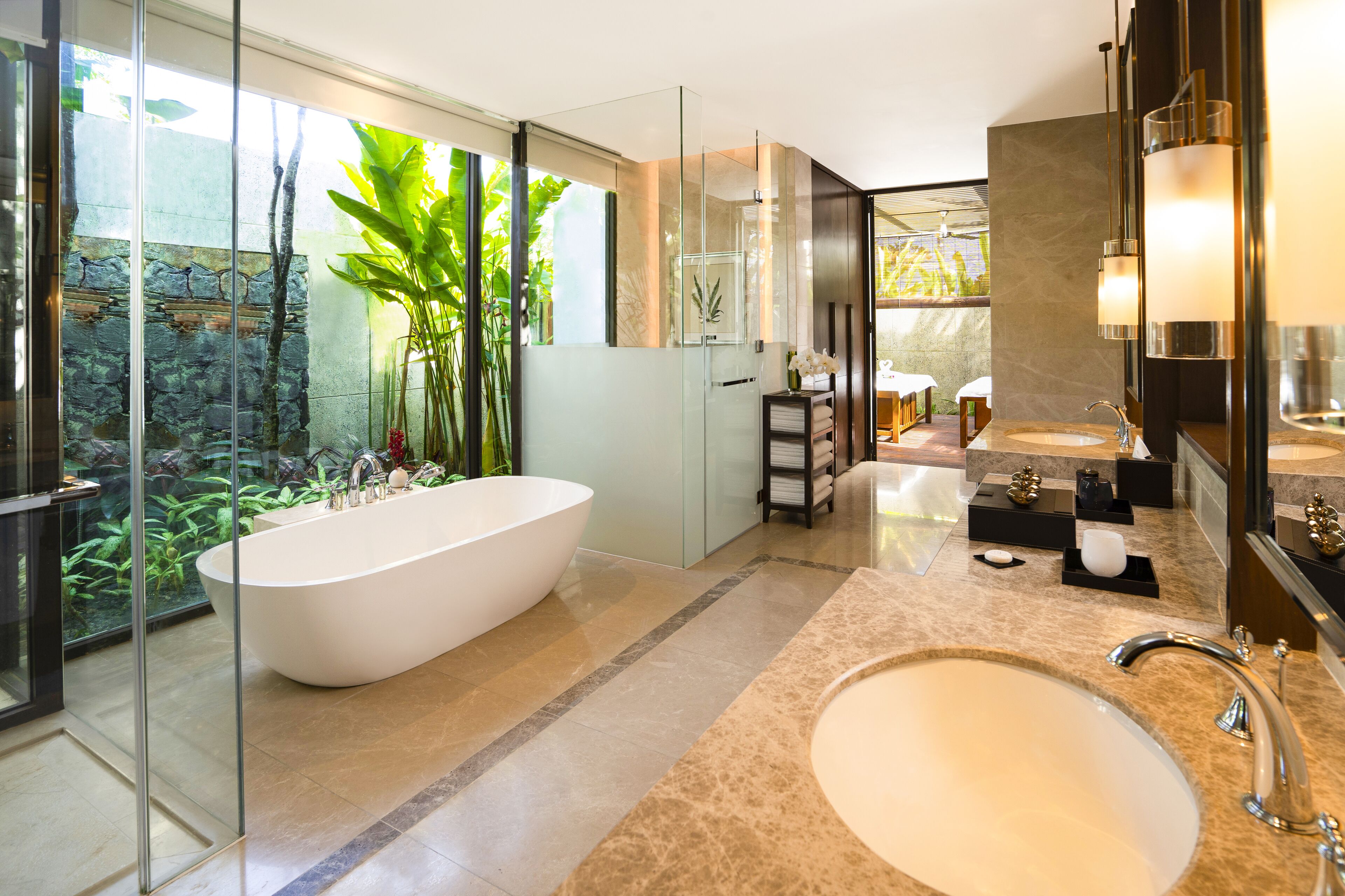 A modern bathroom with a freestanding bathtub, a large sink, and a glass-enclosed shower area.