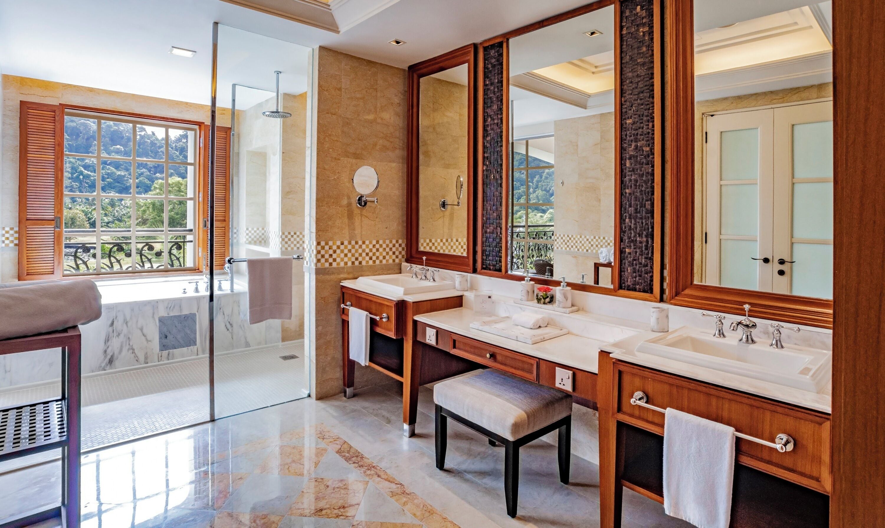 A modern bathroom with two sinks, a large mirror, and a glass-enclosed shower.