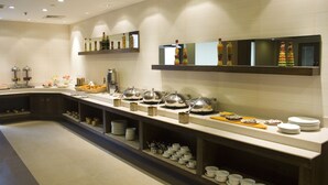 A buffet setup with various food items and serving utensils. - Shervani Hotel Nehru Place (New Delhi)