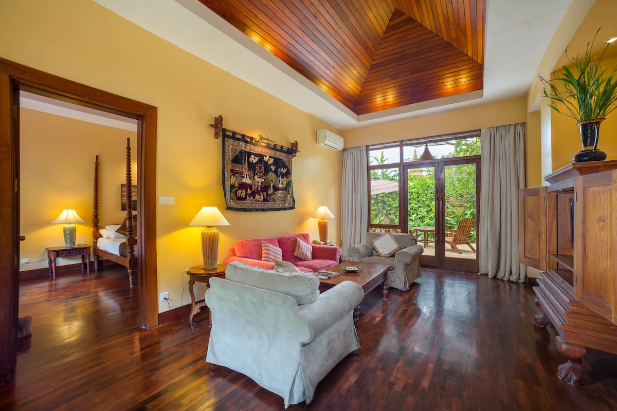 luxury suite, 1 bedroom, kitchenette, garden area | living room | 32-inch flat-screen tv with satellite channels, tv