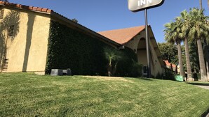 Un letrero del Colton Inn que muestra claramente la arquitectura del edificio, incluyendo un tejado de baldosas y un frente de estuco.
