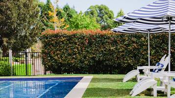 Outdoor pool, open 7 AM to 7 PM, pool umbrellas, pool loungers