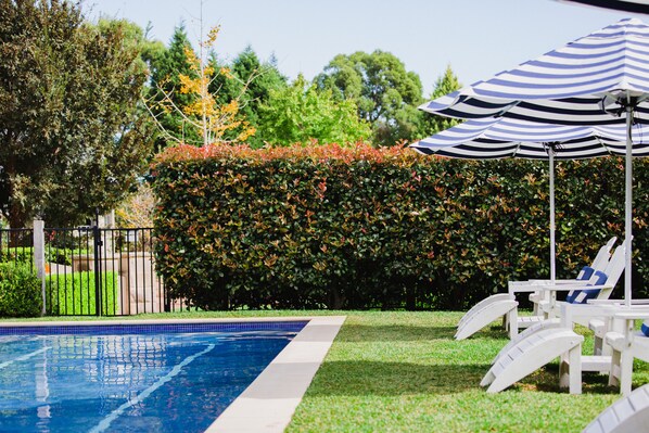 Outdoor pool, open 7 AM to 7 PM, pool umbrellas, pool loungers