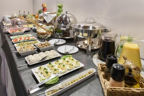 A buffet table with various food items and condiments. - Hotel Nowa Panorama (Kraków)