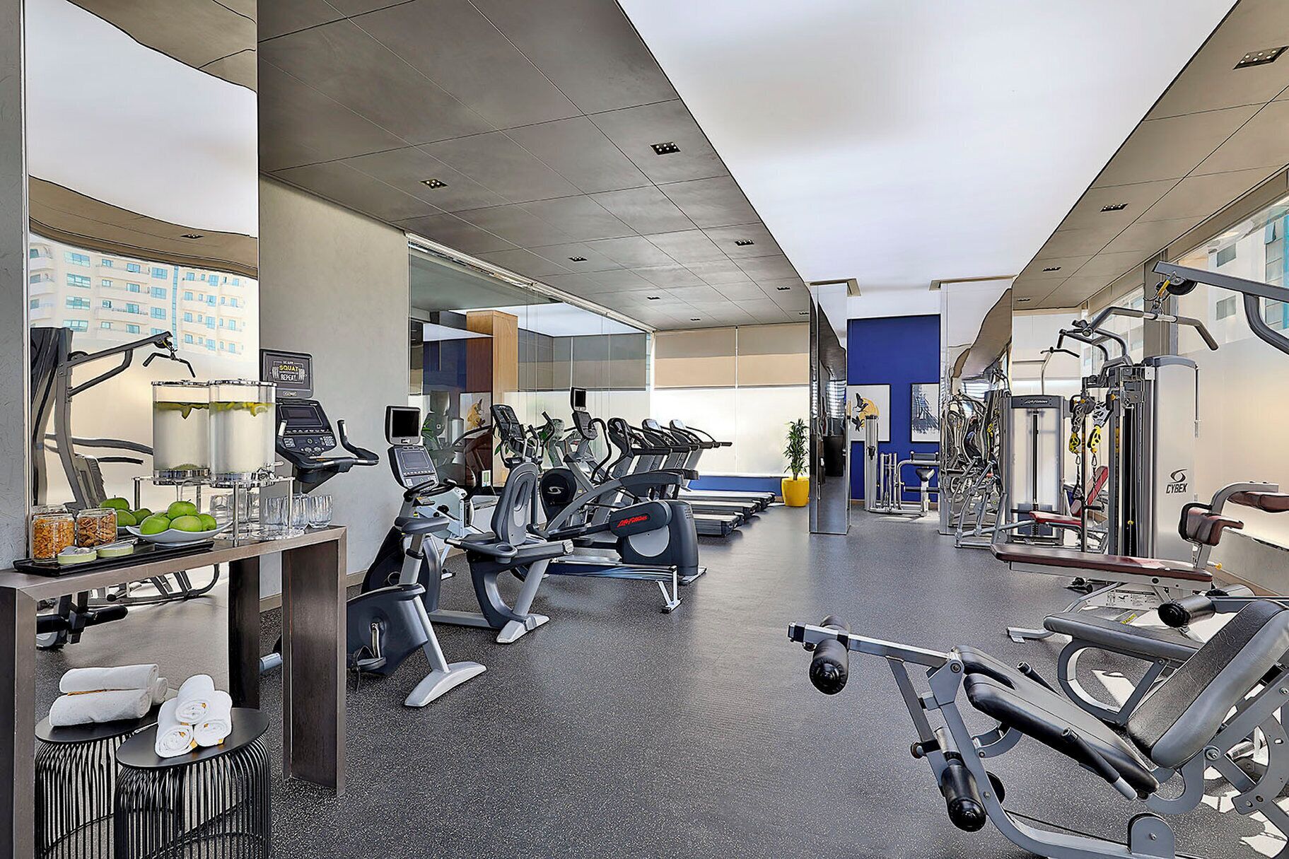 A gym with multiple treadmills, exercise bikes, and weight machines.
