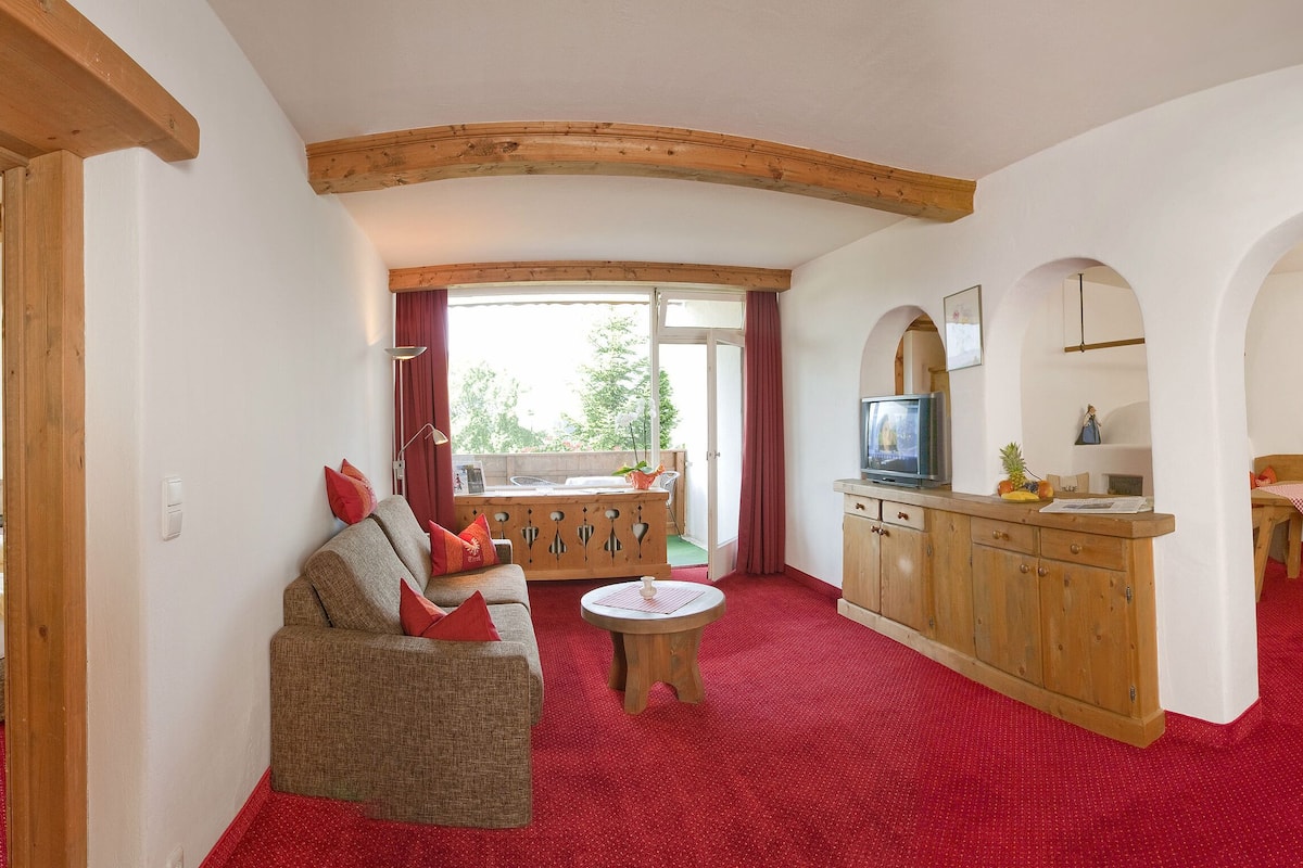 family suite, balcony, mountain view | living area | flat-screen tv