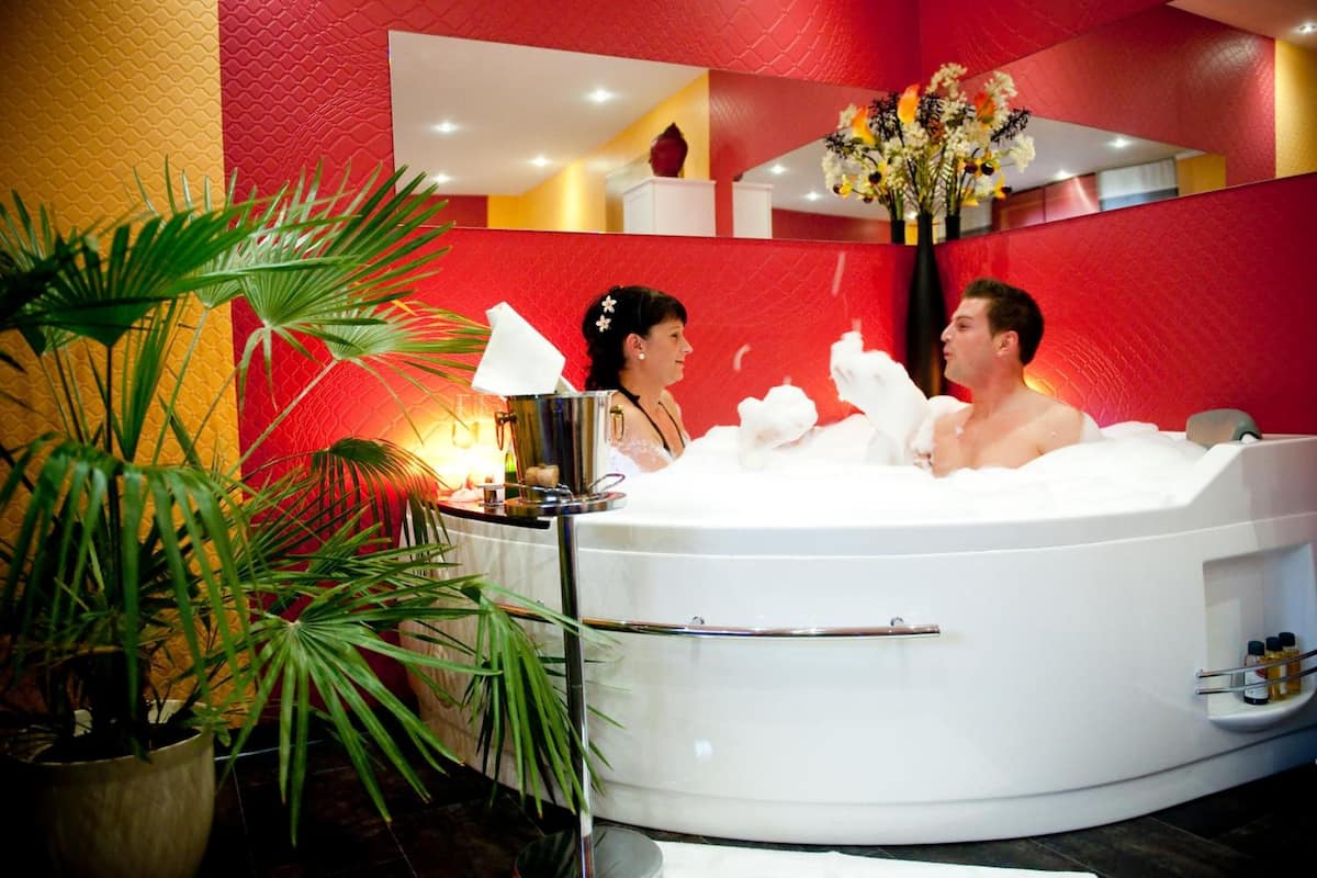 deep-soaking bathtub, rainfall showerhead, hair dryer, bathrobes