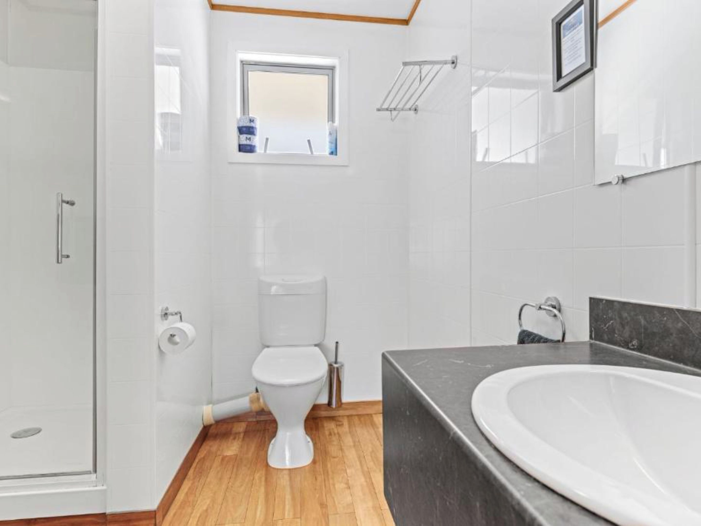 A modern bathroom with a shower, toilet, and bathtub.