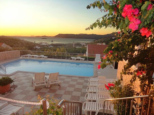 Seasonal outdoor pool, pool umbrellas, pool loungers