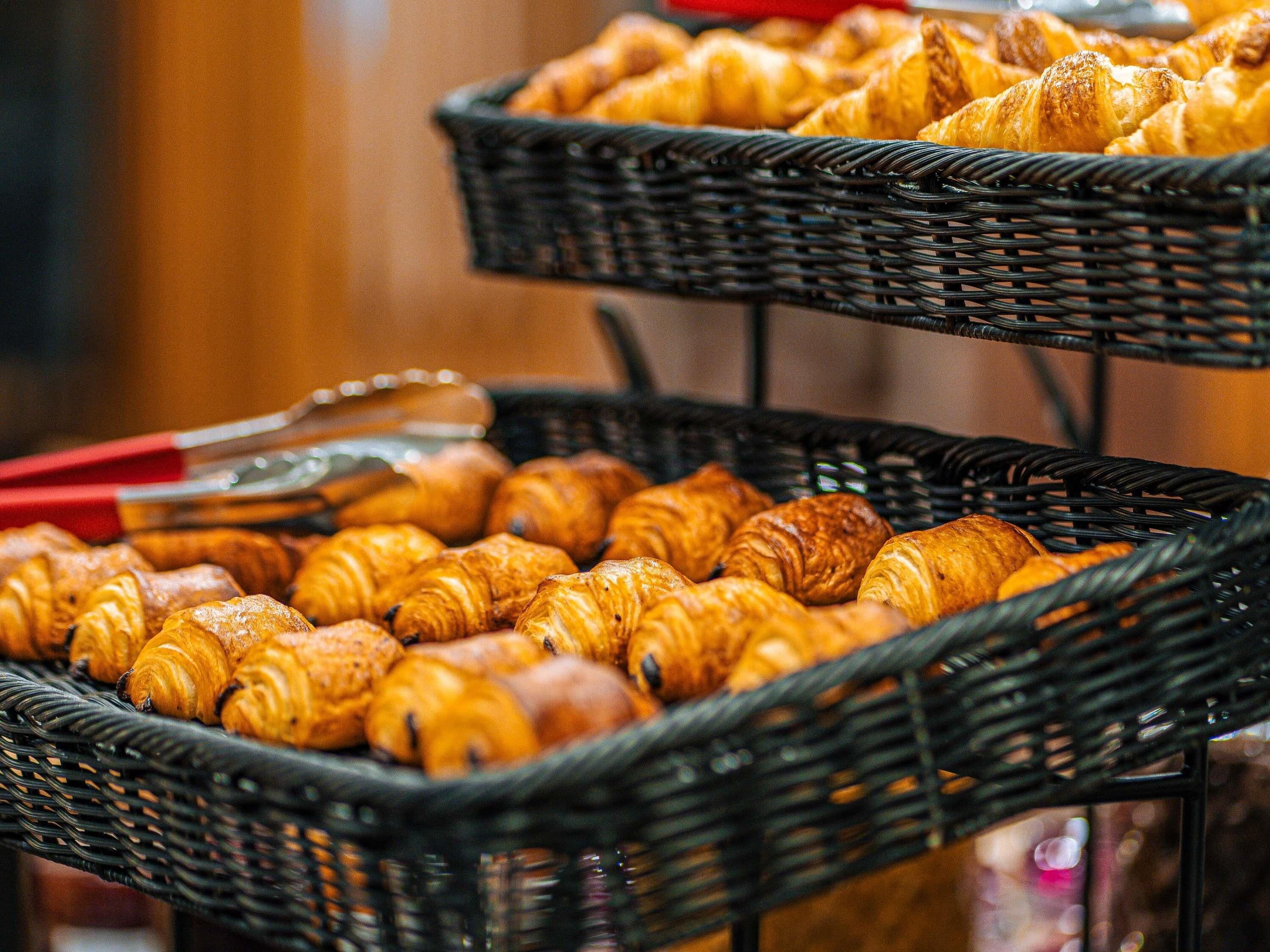 Two wicker baskets filled with assorted pastries.