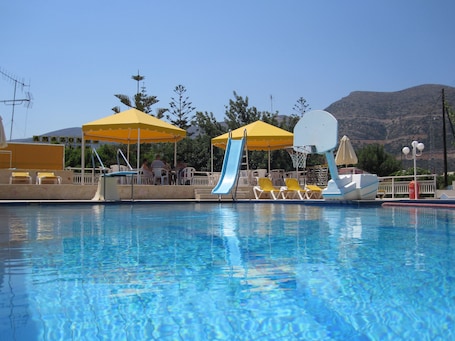 Outdoor pool, open 8:30 AM to 7:30 PM, pool umbrellas, pool loungers. Amazones Villas Apartments