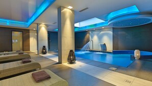 A modern spa area with massage tables, a hot tub, and a pool. - Castello Boutique Resort & Spa - Adults Only (Agios Nikolaos)
