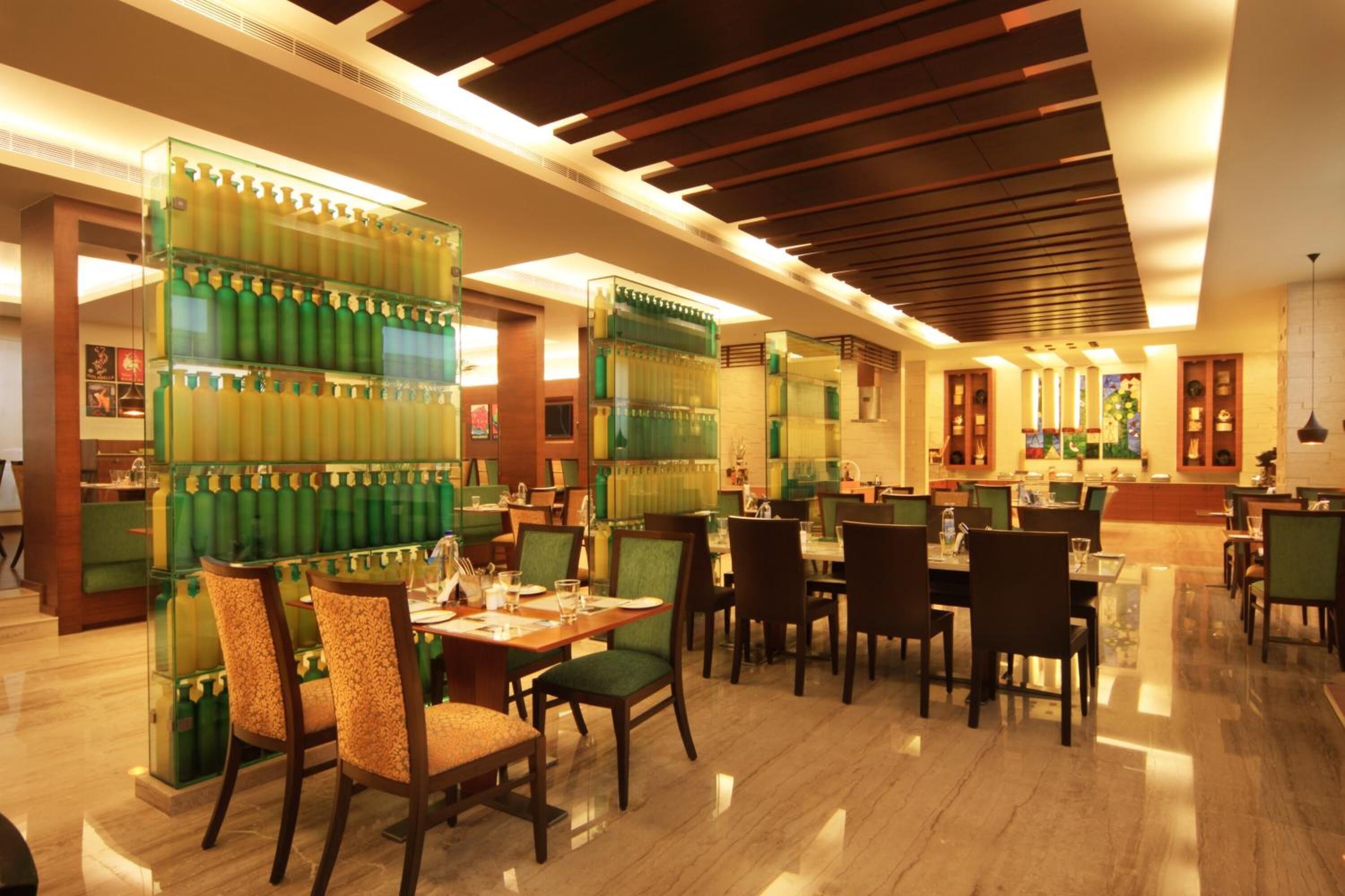 A spacious restaurant with high ceilings, modern lighting, and a clean, polished floor.