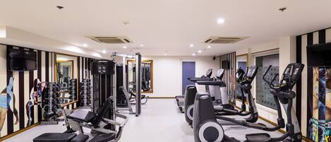 A gym with various exercise equipment, including treadmills and weight machines.