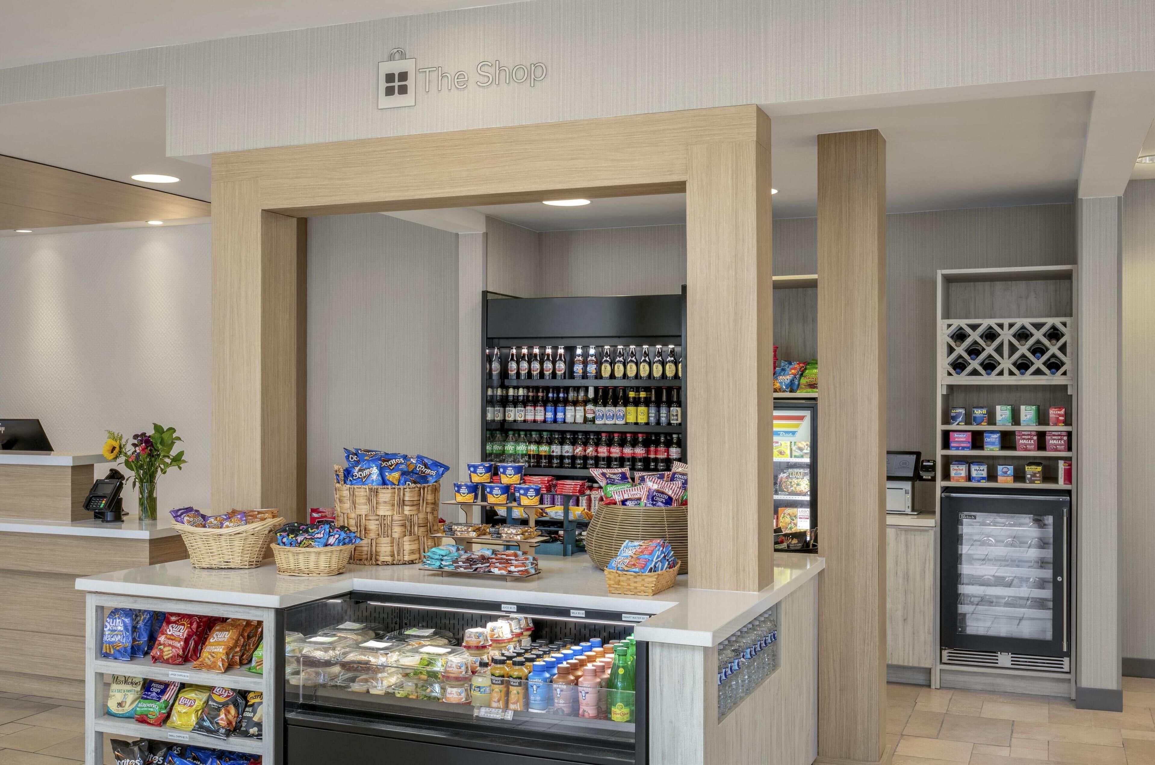 A modern retail area with a variety of products including snacks, beverages, and packaged goods.