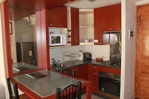 Full-sized fridge, microwave, stovetop, coffee/tea maker
