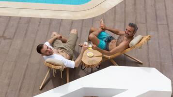Seasonal outdoor pool, open 9 AM to 7 PM, pool umbrellas, pool loungers