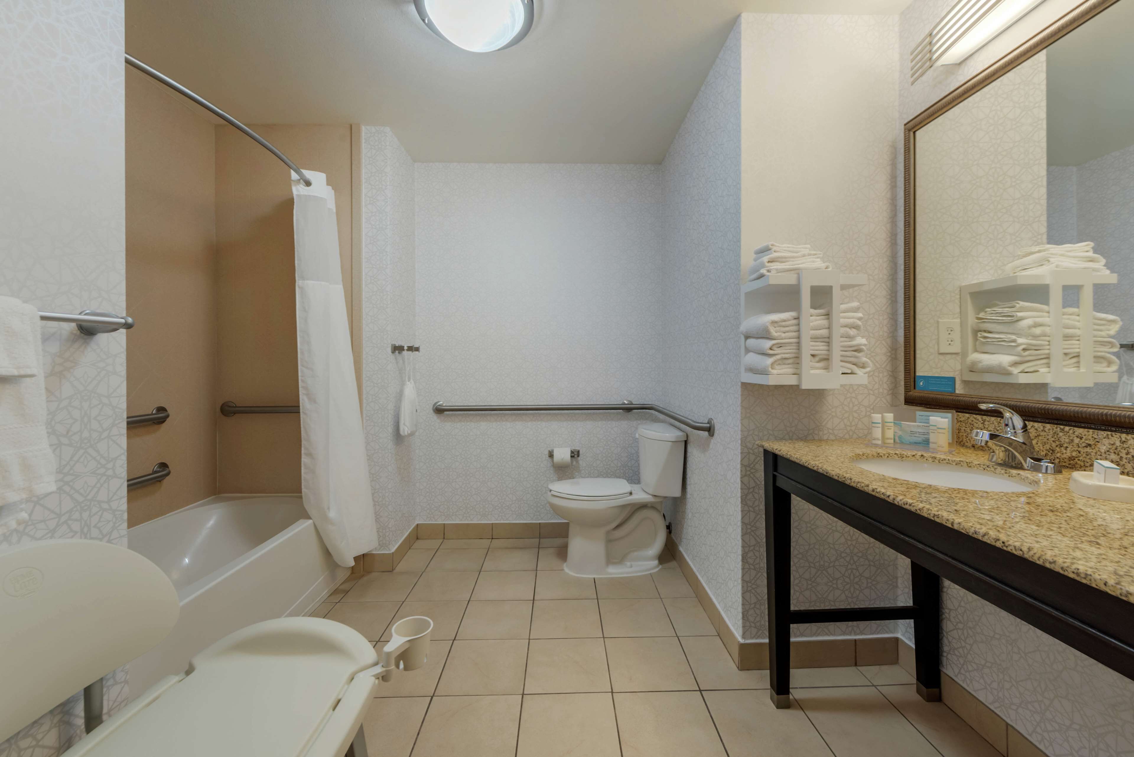 A bathroom with a bathtub, toilet, and sink.
