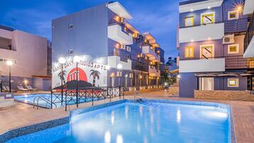 Seasonal outdoor pool, open 9:00 AM to 8:00 PM, pool umbrellas