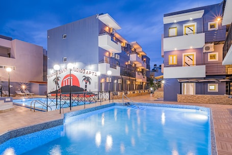 Seasonal outdoor pool, open 9:00 AM to 8:00 PM, pool umbrellas. Happy Days Studios