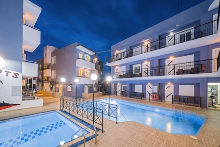Seasonal outdoor pool, open 9:00 AM to 8:00 PM, pool umbrellas