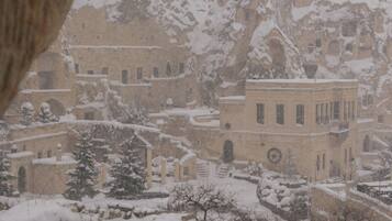 A snowy landscape with buildings and trees.