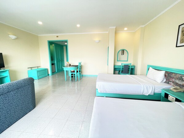 A hotel room with two beds, a desk, a chair, and a television. - Bat Dat Hotel (Ho Chi Minh City)