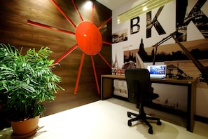 Work in style with a desk and office chair, surrounded by inspiring architectural photographs and a unique accent wall.