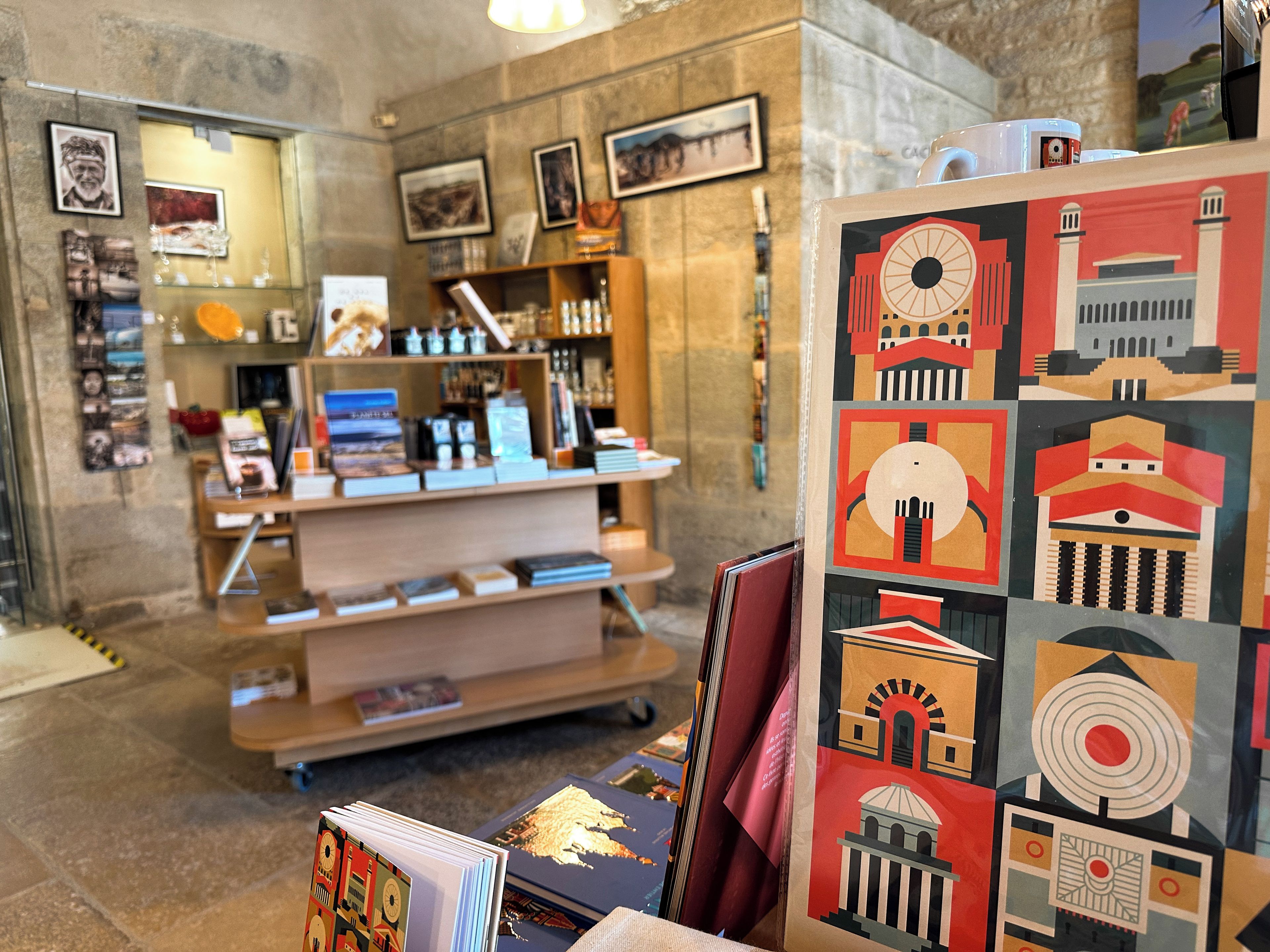 A bookstore with shelves of books and framed artwork on the walls.