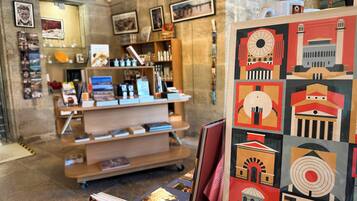A bookstore with shelves of books and framed artwork on the walls.
