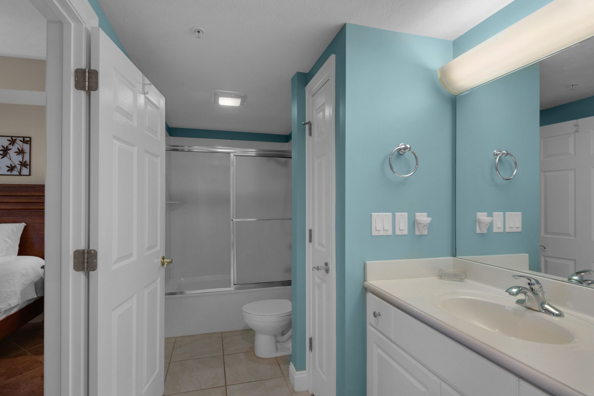A bathroom with a shower, toilet, and sink.