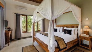 A bedroom with a four-poster bed, a wooden nightstand, a TV, and a window with curtains. - Kubu Rama Ubud Cottage (Ubud)