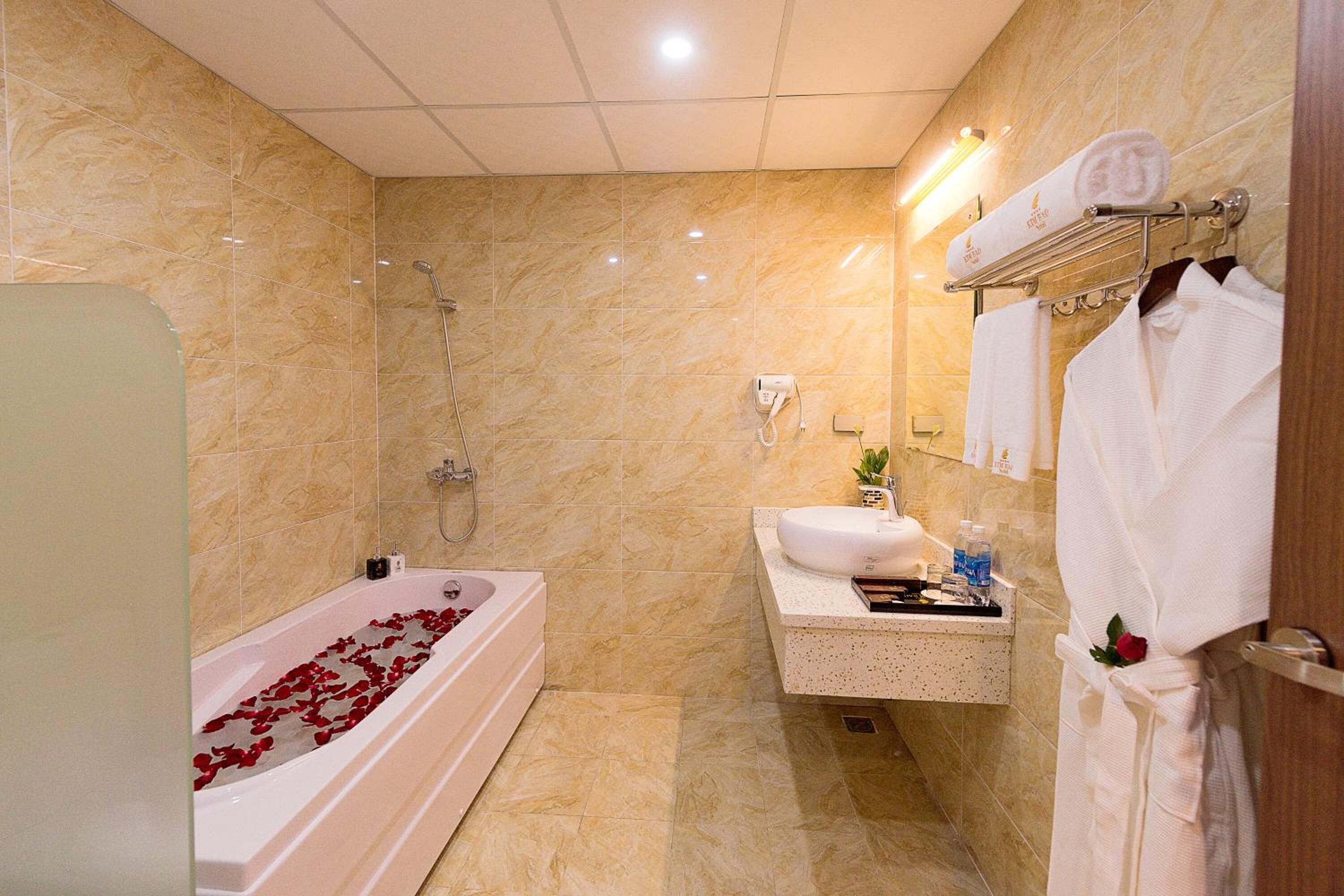 A modern bathroom with a bathtub, shower, and vanity.