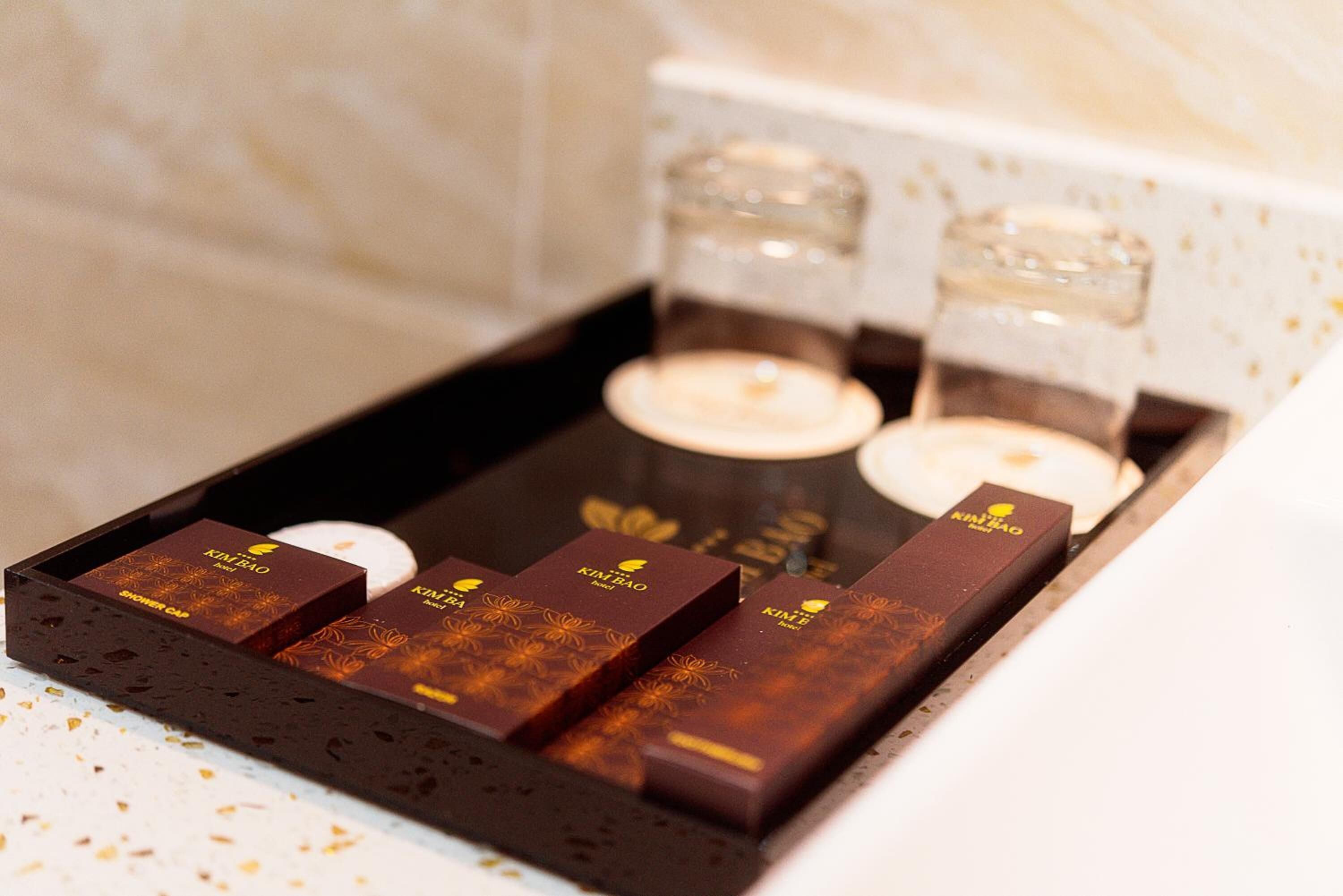 A tray with four chocolate bars and two candles.