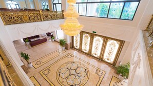 A grand lobby with a chandelier, ornate railings, and a reception desk. - Kim Bao Hotel (Hai Phong)
