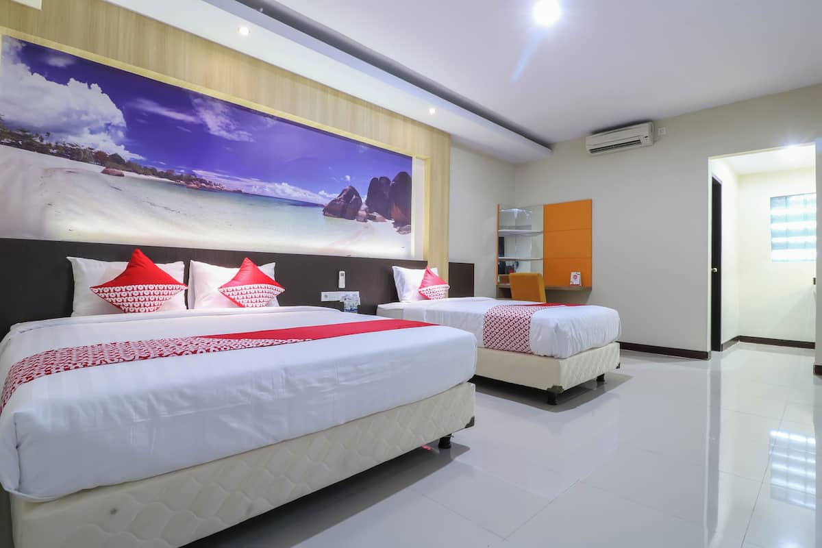 A hotel room with two beds, a large beach-themed wall mural, and a modern design.