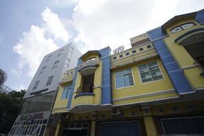 A hotel with a yellow facade, a balcony, and a sign indicating it is a hotel. - Super OYO 1173 Hotel Shofa Marwah (Palembang)