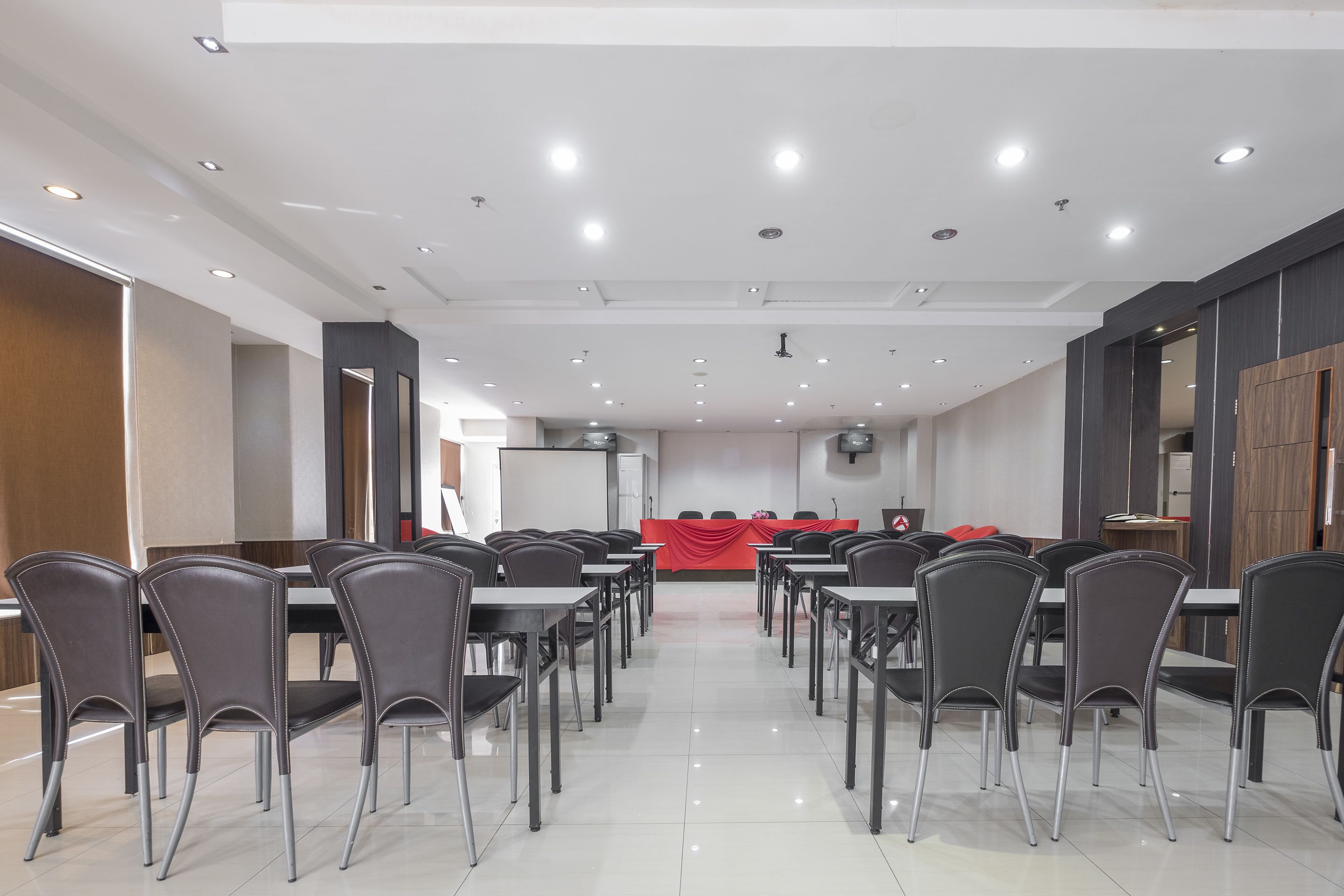 A conference room with tables and chairs arranged for meetings.