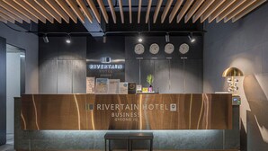 A reception desk at Rivertain Hotel with clocks displaying time in London, Korea, Paris, and Beijing. - Rivertain Hotel Gyeongju (Gyeongju)