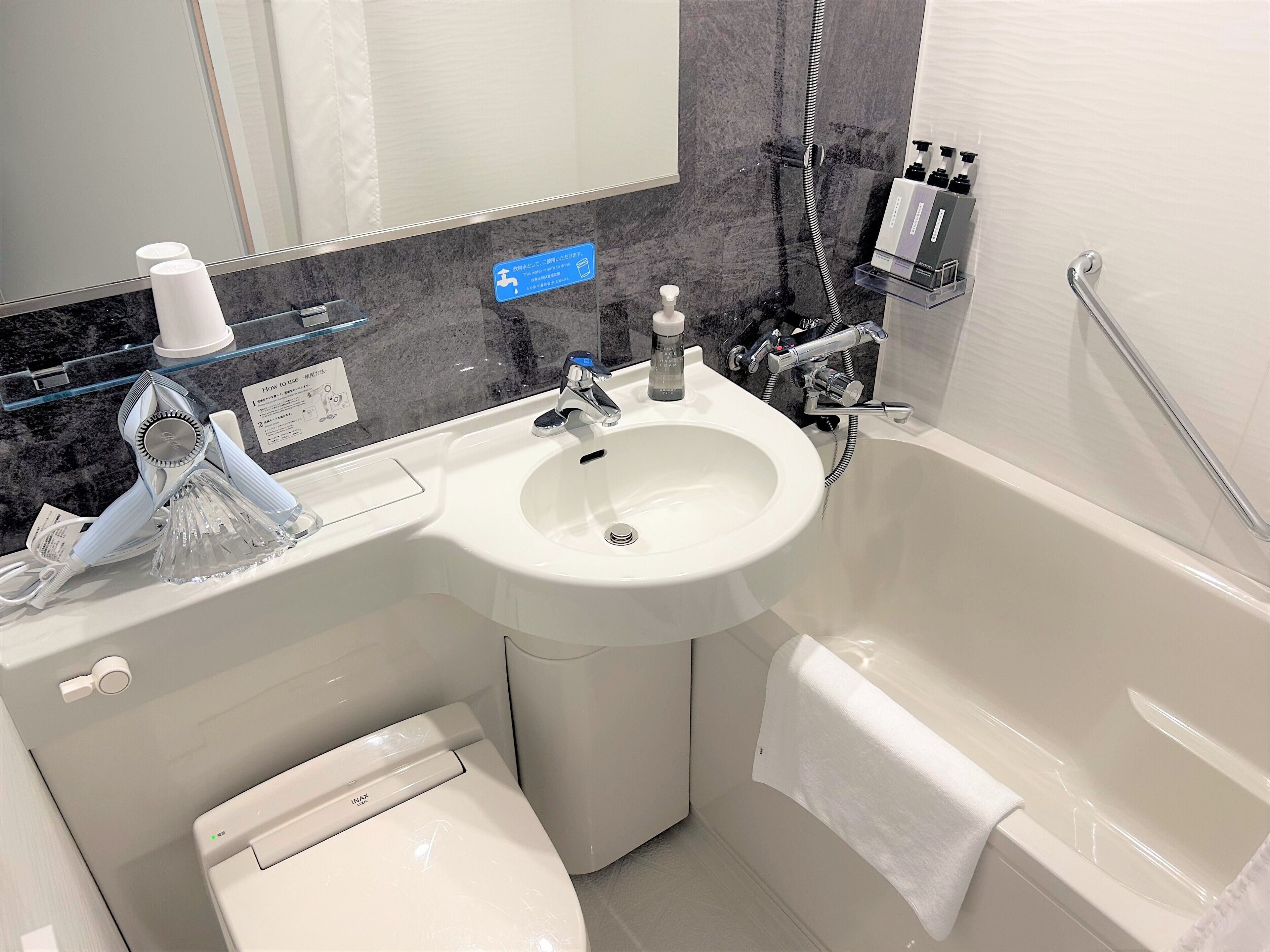 combined shower/bathtub, free toiletries, hair dryer, slippers